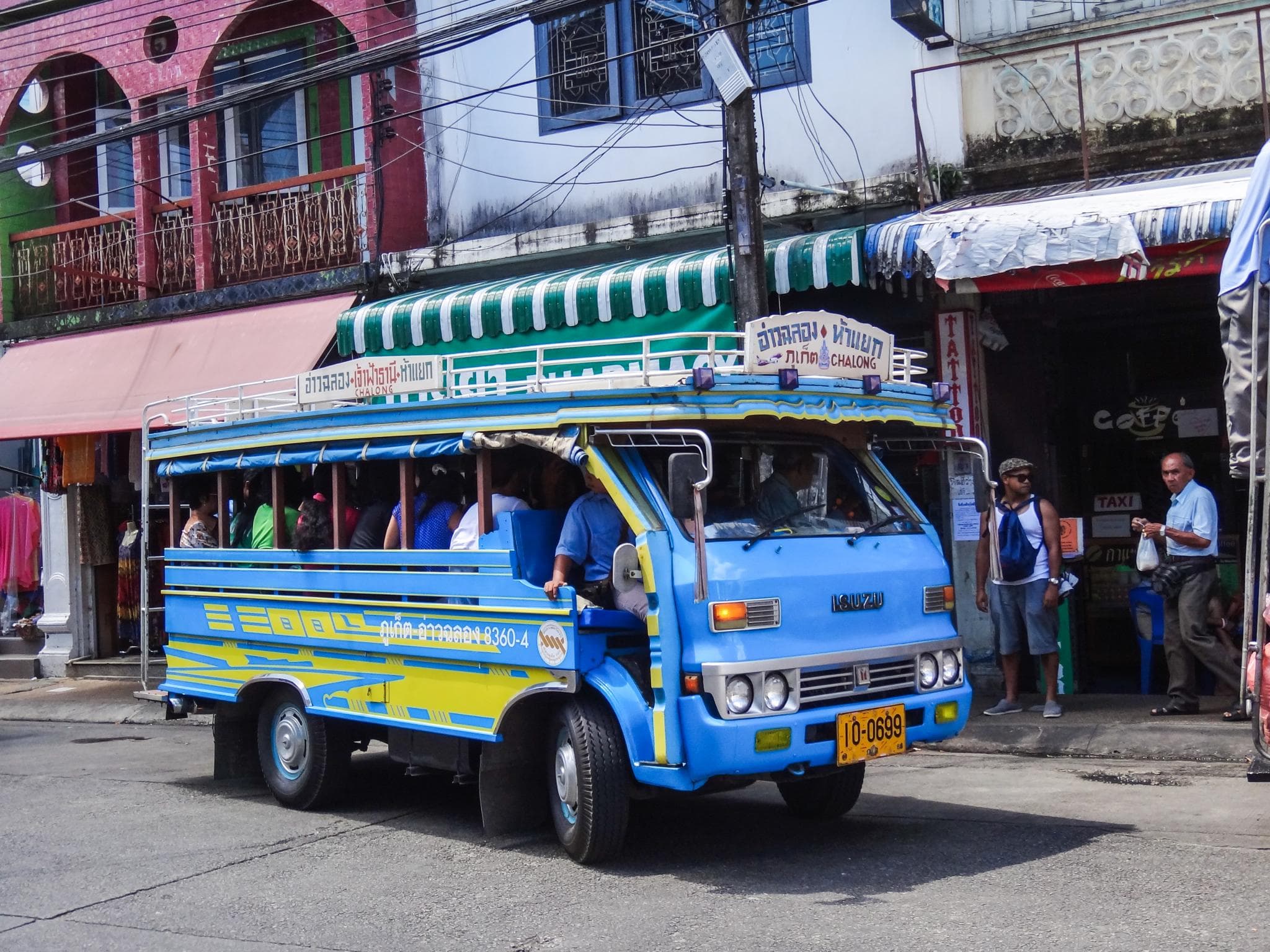 A blue songthaew on a Phuket street